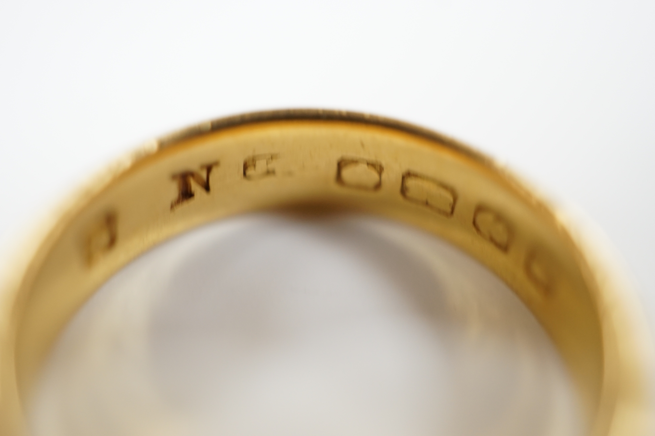 A 22ct. gold wedding band, size N, 7.2 grams.